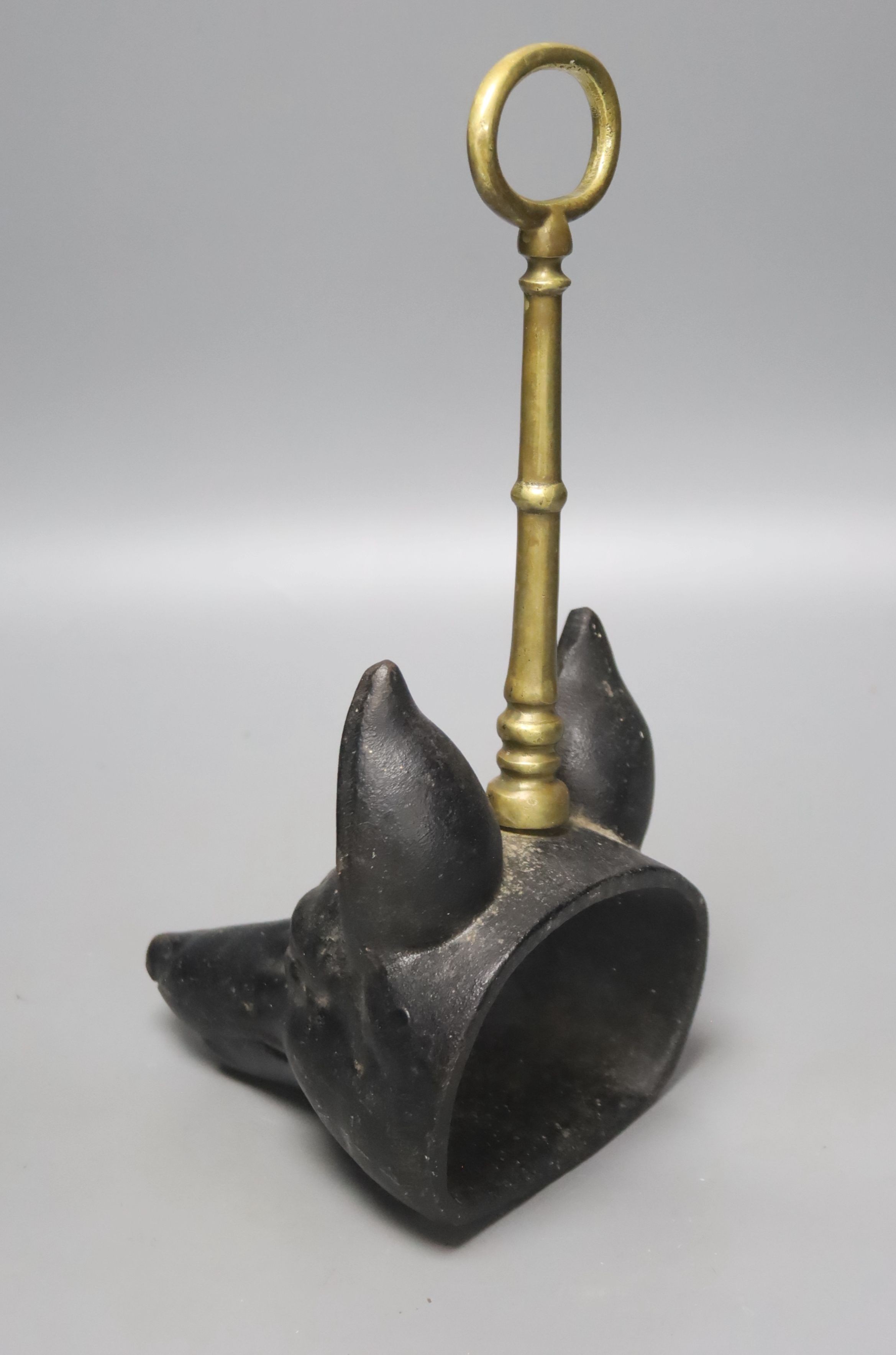 A cast iron and brass foxhead doorstop, 30cm tall